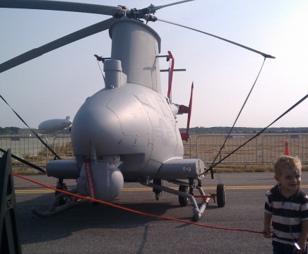 A young boy checks out a MQ-8B Fire Scout on display at the 2011 Pax River Air Expo. (Photo by Jay Friess)