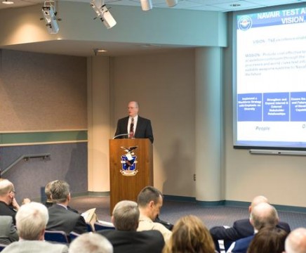 Black Belt Andy Ashenfelter presents the CH-53K Day-in-the-Life Model at Continuous Process Improvement Update Day held Oct. 5. The model identifies the quantity and type of required staffing necessary to meet CH-53K program goals. (U.S. Navy photo)