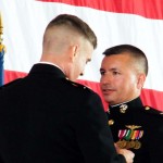 Col. Roger Cordell pins Col. Charles Gray with a medal for his service as commander of VX-23.