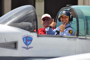 Cadet thumbs up cockpit w plane Midway logo
