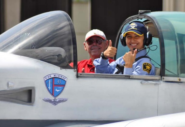 Cadet thumbs up cockpit w plane Midway logo
