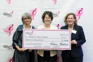 Tami Gaido, MedStar St. Mary’s Hospital health educator, Women’s Wellness case manager and registered nurse (center), accepts a ceremonial check from two representatives of the Maryland Affiliate of Susan G.  Komen for the Cure. The grant funds are for the Pink Ribbon Project. 