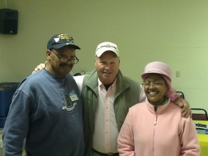 Nace Bowman (l) and Francine Dove-Hawkins of St. Peter Claver Church flank the WARM volunteer driver Jack Russell