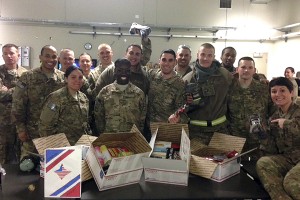 U.S. Air Force men and women serving at Bagram Airfield in Afghanistan pose with the care packages they received from CSM Phi Theta Kappa Honor Society. 