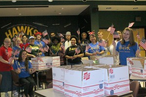 CSM Phi Theta Kappa Honor Society President Kellee Johnson of Leonardtown, organizer of the care package mailing, right, is joined by CSM students representing several collegiate clubs who participated in assembling 136 boxes for service men and women at Bagram Airfield in Afghanistan.